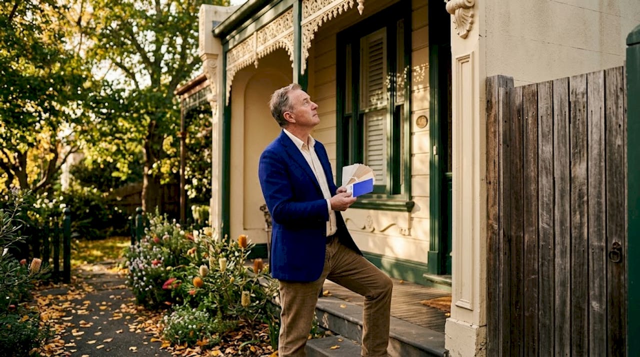 Man studying Victorian home paint samples