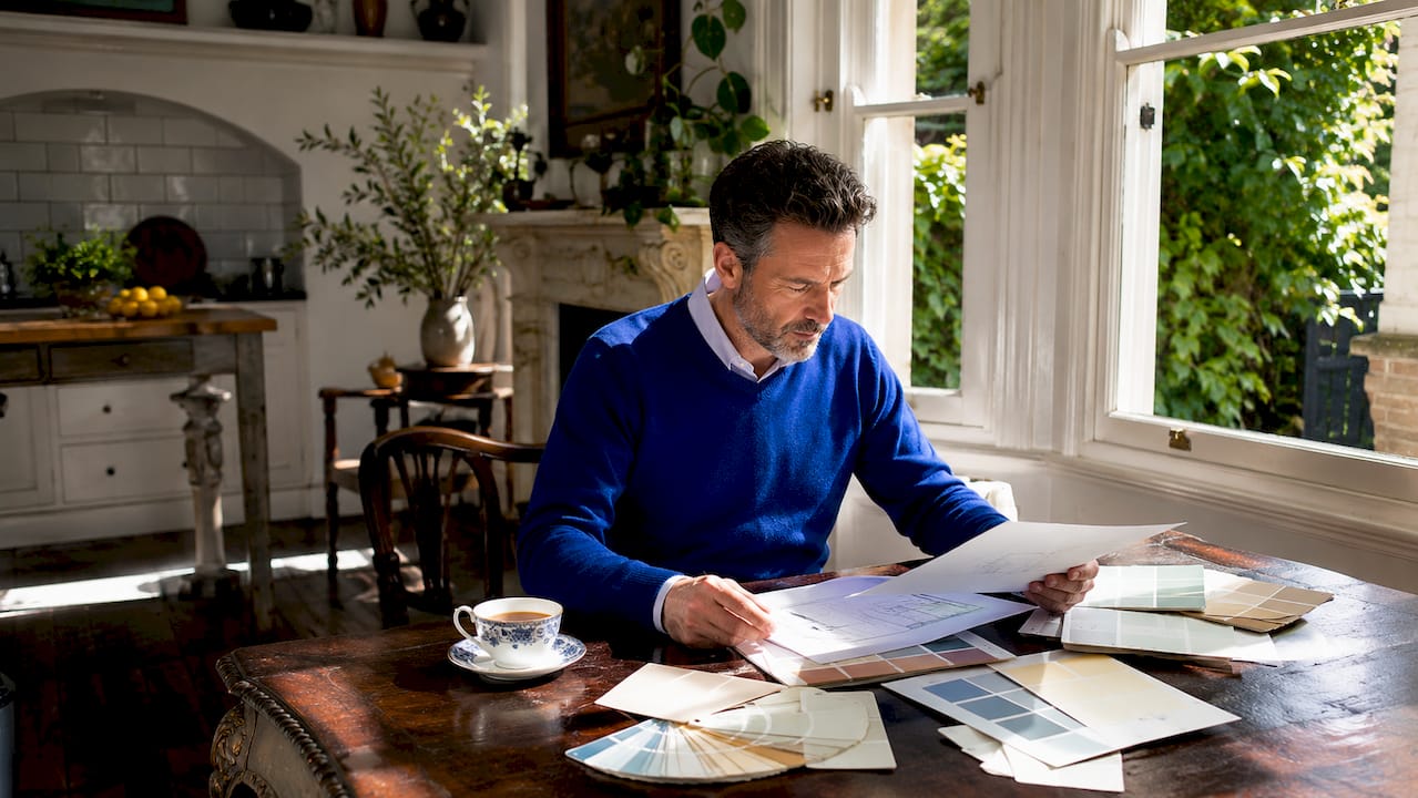 Homeowner reviewing heritage paint compliance documents