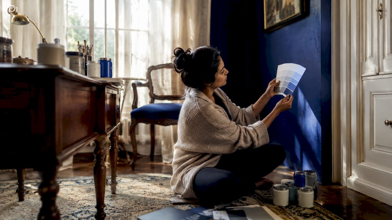 Colour consultant assessing paint colours in living room