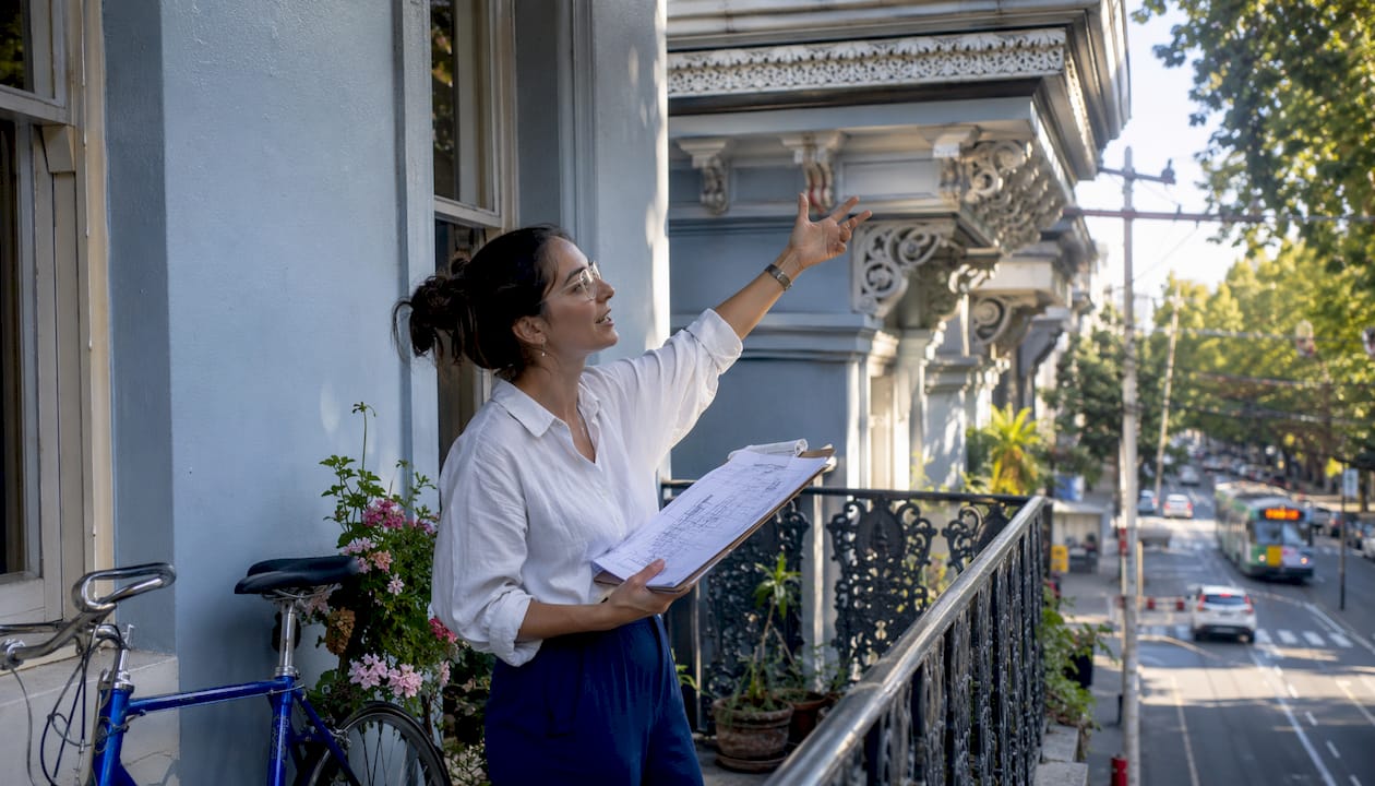Architect examining Edwardian home facade outdoors