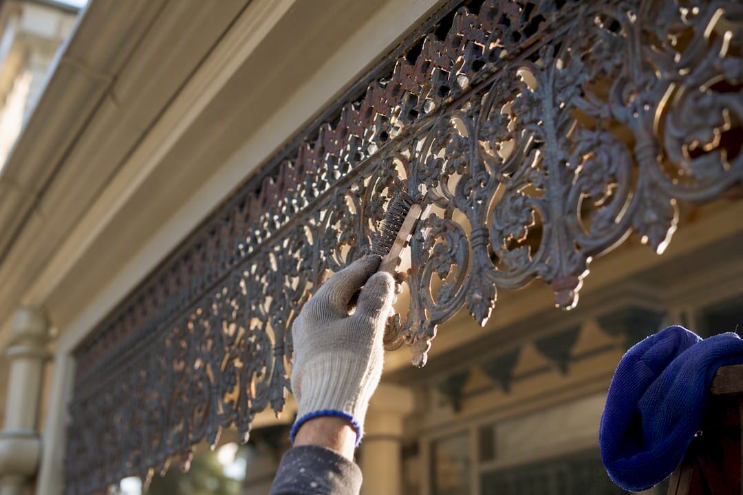 Restorer preparing intricate Victorian iron lacework