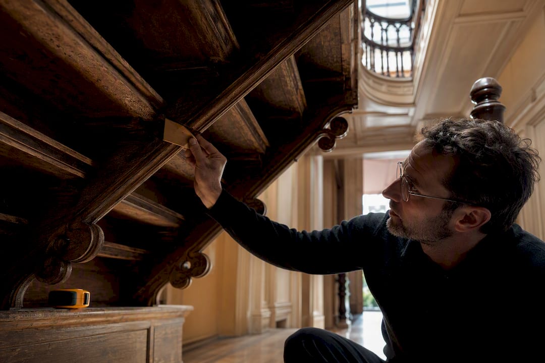 Conservator inspecting Victorian staircase structure