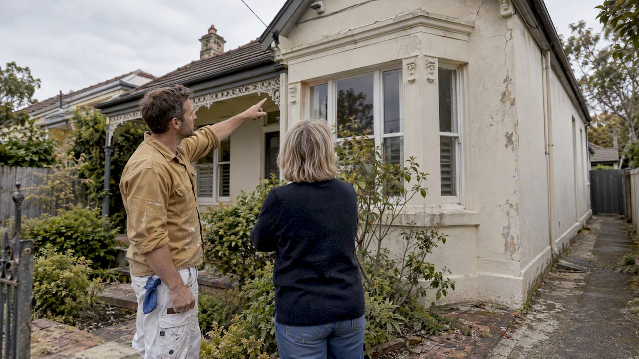 Painter inspecting Melbourne rendered home's exterior