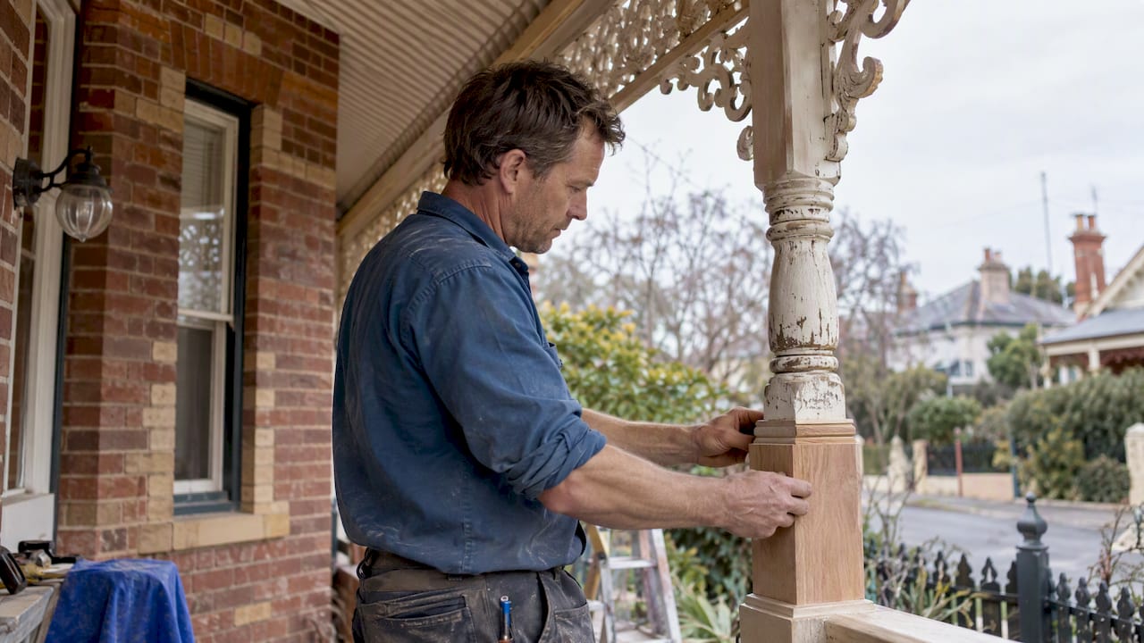 Carpenter restoring a Victorian verandah post