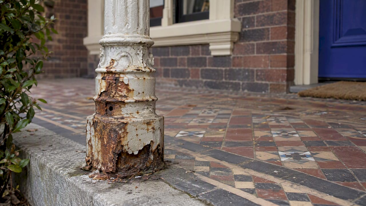 Rust lifting paint on cast iron column base